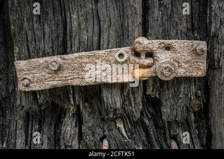 old wooden door with rusty hinge Stock Photo