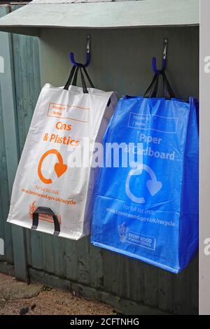 Recycle logo on bins in form of local council authority blue & white plastic bag sacks for waste management  recycling of garbage rubbish England UK Stock Photo