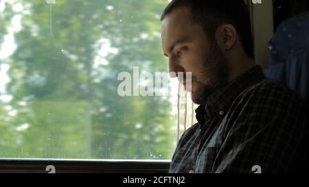 Businessman Commuting On Train Using Digital Tablet. Stock Photo