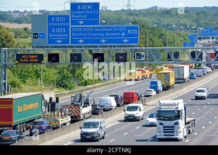 M25 motorway queue traffic close up electronics digital technology road sign fire engine emergency services traffic accident closed  lanes Brentwood Stock Photo