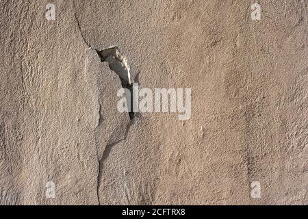 Old cracked weathered shabby red yellow painted plastered peeled wall Stock Photo