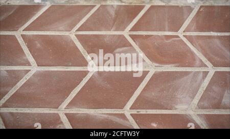 a worker laying red concrete paving blocks. Lay paving stones Stock Photo