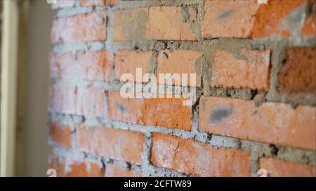 Brick ready to build house wall in a construction site. Brick wall, masonry, ready for repair. Stock Photo