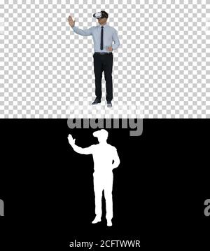 Businessman in VR glasses and interacting with virtual reality objects, Alpha Channel Stock Photo