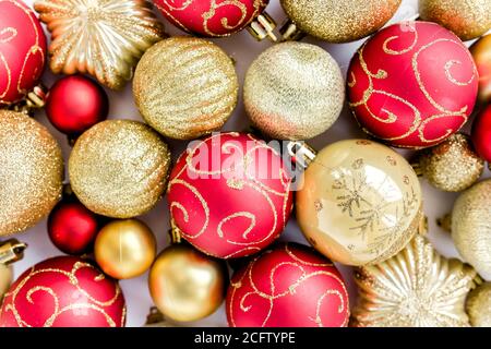 Christmas texture: red and gold glass Christmas balls on a white background. the apartment lay, top view Stock Photo