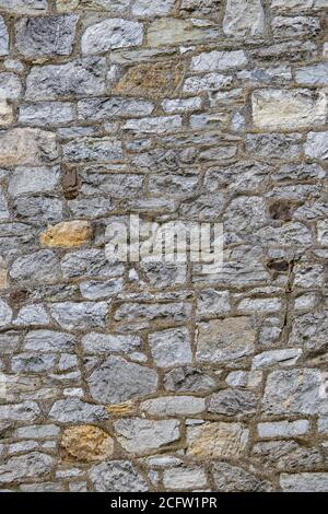 Vertical closeup shot of textured stone wall Stock Photo