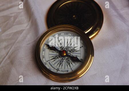 Luxury marine compass gold plated with sapphire embedded on the needle Stock Photo