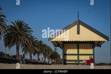 Reading on beach. Relaxing with a good book by the sea. Stock Photo