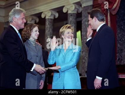 Photograph of Vice President Al Gore Administering Oath to Senator Hillary Rodham Clinton as President Bill Clinton and Daughter Chelsea Watch 1/3/2001 Stock Photo