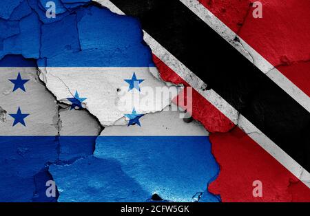 flags of Honduras and Trinidad and Tobago painted on cracked wall Stock Photo
