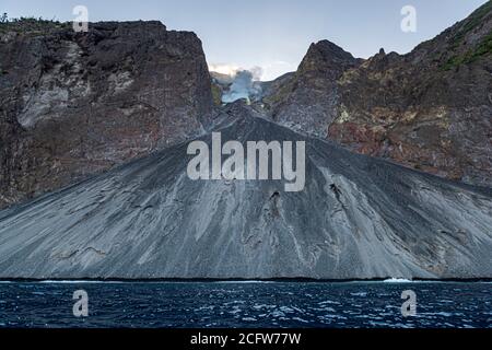 The smell of sulfur from the active Batu Tara volcano on the indonesian island of Pulau Komba can even be smelled in the helicopter Stock Photo