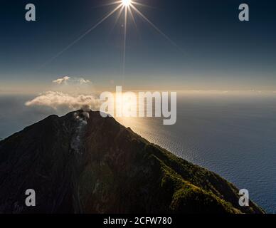 The smell of sulfur from the active Batu Tara volcano on the indonesian island of Pulau Komba can even be smelled in the helicopter Stock Photo