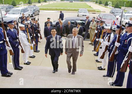 The Honorable Donald H. Rumsfeld, U.S. Secretary of Defense, (right) escorts the President of Mongolia, Natsagiyn Bagabandi (left), through an honor cordon outside the Pentagon, Washington, D.C., on July 15, 2004. Stock Photo