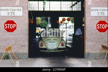 A Volkswagen Bug (beetle) Car Has Just Entered the Safety Lane at an Auto Emission Inspection Station in Downtown Cincinnati, Ohio September 1975 Stock Photo