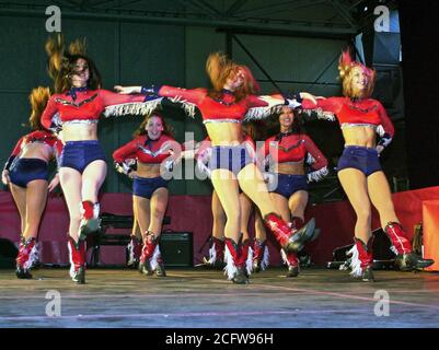 The Dallas Cowboys Cheerleaders perform during the Secretary of Defense Holiday Tour 2000, in Hangar 3 at Ramstein Air Base, Germany, on December 17th 2000. Stock Photo