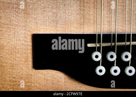 Abstract closeup of spruce top and bridge on 12 string guitar Stock Photo