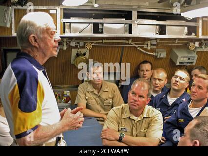 2005 - Former US President James E. Carter addresses the crew onboard his namesake ship, the Sea Wolf Class Attack Submarine USS JIMMY CARTER (SSN 23) in the crew's mess. President Carter and his wife, Rosalynn, spent the night aboard the submarine, touring the ship and meeting with crew members. The USS JIMMY CARTER is the third in Sea Wolf Class Attack Submarine. Stock Photo