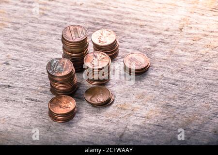 Stacks of old pennies on a wooden table Stock Photo