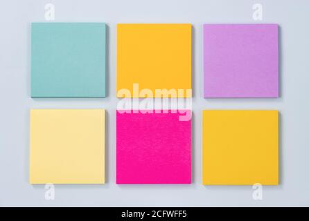 6 Color Sticky Note or Note Pad as Green,Purple,Pink,Yellow on Modern Clean Creative Office Desk or Office Table on Top View. Office Supplies on Blue Stock Photo