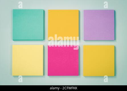 6 Color Sticky Note or Note Pad as Green,Purple,Pink,Yellow on Modern Clean Creative Office Desk or Office Table on Top View. Office Supplies on Blue Stock Photo