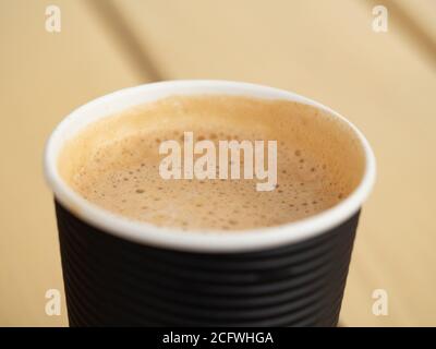 Full paper glass of coffee. Foam texture. Close-up top-down view Stock Photo