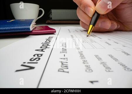 Close Up Of A Visa Application Document With A German Passport On Table 