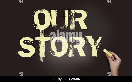 Our story words in pale yellow on blackboard and hand with chalk. Personal branding concept. Business concept Stock Photo