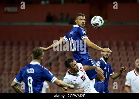 Zenica, Bosnia and Herzegovina. 7th Sep, 2020. Edin Dzeko (top) of Bosnia and Herzegovina (BiH) competes during the UEFA Nations League football match between BiH and Poland in Zenica, Bosnia and Herzegovina, on Sept. 7, 2020. Credit: Nedim Grabovica/Xinhua/Alamy Live News Stock Photo