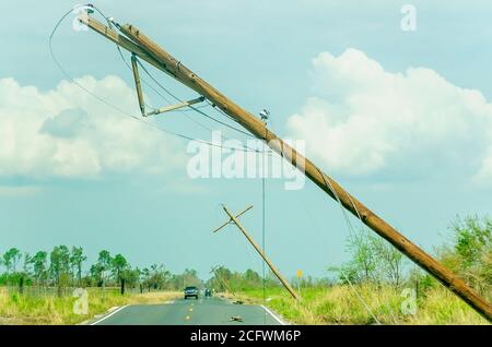 Drivers pass damaged power lines on Ward Line Road after Hurricane Laura, Sept. 6, 2020, in Bell City, Louisiana. Stock Photo