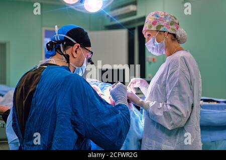 concentrated surgeon during an operation Stock Photo