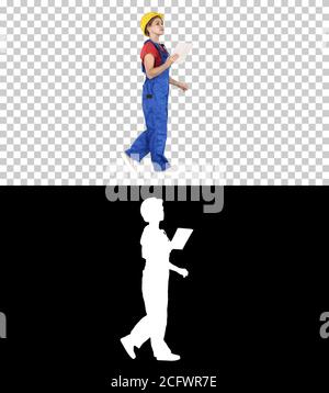 Construction lady using electronic tablet walking, Alpha Channel Stock Photo
