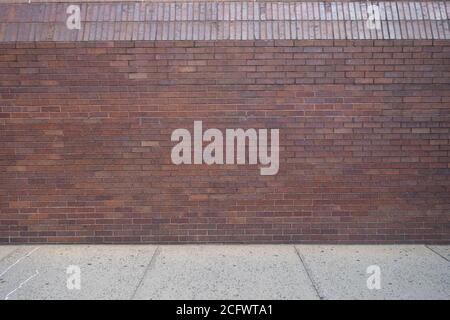 outdoor wlakway sidewalk with red brick wall Stock Photo