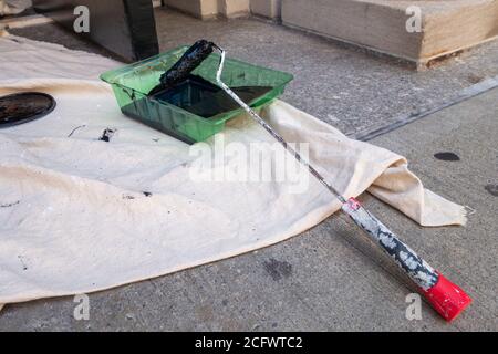 Small roller with black paint on throw trap and Paint Roller tray Stock Photo