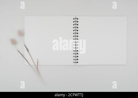 Blank spiral bound sketchbook with empty open page. Top view real