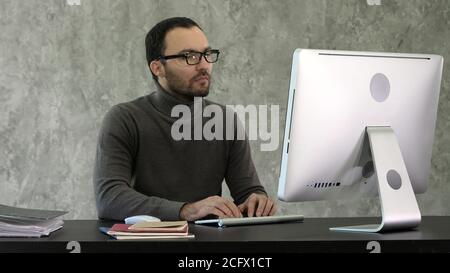 Programming. Man Working On Computer In IT Office, Sitting At Desk Writing Codes. Programmer Typing Data Code, Working On Project In Software Stock Photo