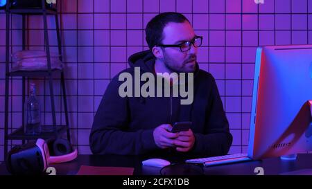 Hacker using mobile smartphone and stealing personal information through data in order to scamming ransom. Stock Photo