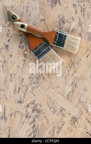 two brushes lies on wooden surface, prepared for painting Stock Photo