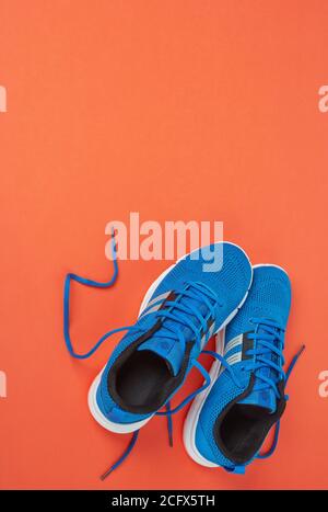 Blue sport shoes on orange background Stock Photo