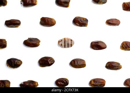 sweet dried dates laid out in several rows on the white background Stock Photo
