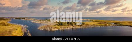Beautiful panoramic high angle aerial drone shot of islands on one of Gorkoje lakes in Altai Krai, Siberia, Russia. Sunset cloudy sky in the backgroun