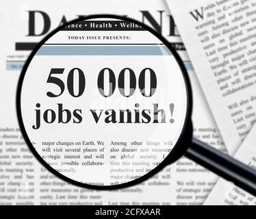 50 000 jobs vanish headline under magnifying glass Stock Photo