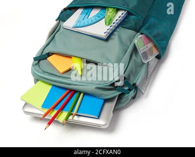 School bag with supplies on white background Stock Photo