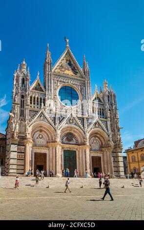 Lovely portrait shot of the impressive west façade of the historic Duomo di Siena, the famous medieval church in Siena, Italy. The cathedral is a... Stock Photo