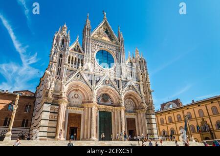 Picturesque view of the impressive west façade of the Duomo di Siena, the famous medieval church in Siena. Built using polychrome marble, the façade... Stock Photo