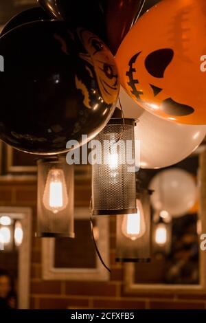 Electric lamps and balloons as Halloween decor in a cafe Stock Photo