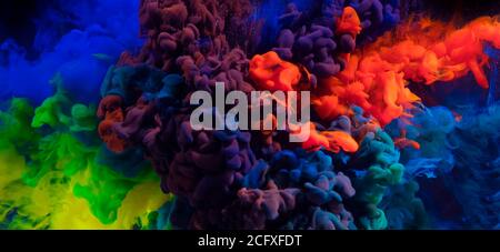Mix of coloured inks in water on black background. Abstract colored background Stock Photo