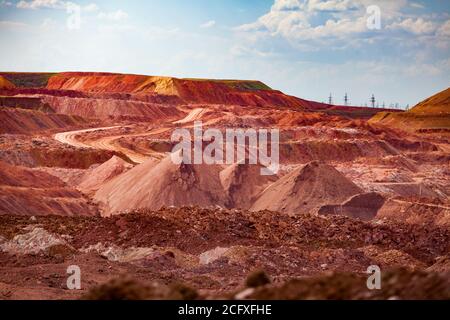 Aluminium ore quarry. Bauxite clay open-cut mining. Heaps of empty rocks and ore. Stock Photo