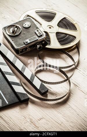 Vintage film claper with film reel placed on wood. Filmammakers equipment  background Stock Photo - Alamy