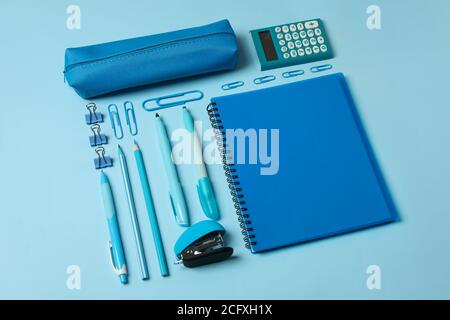 Flat lay with different school supplies on blue background Stock Photo