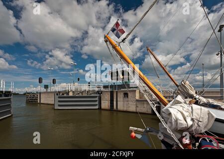 Traditional sailship leaving a sluice at the Markermeer in The Netherlands near the city of Enkhuizen Stock Photo